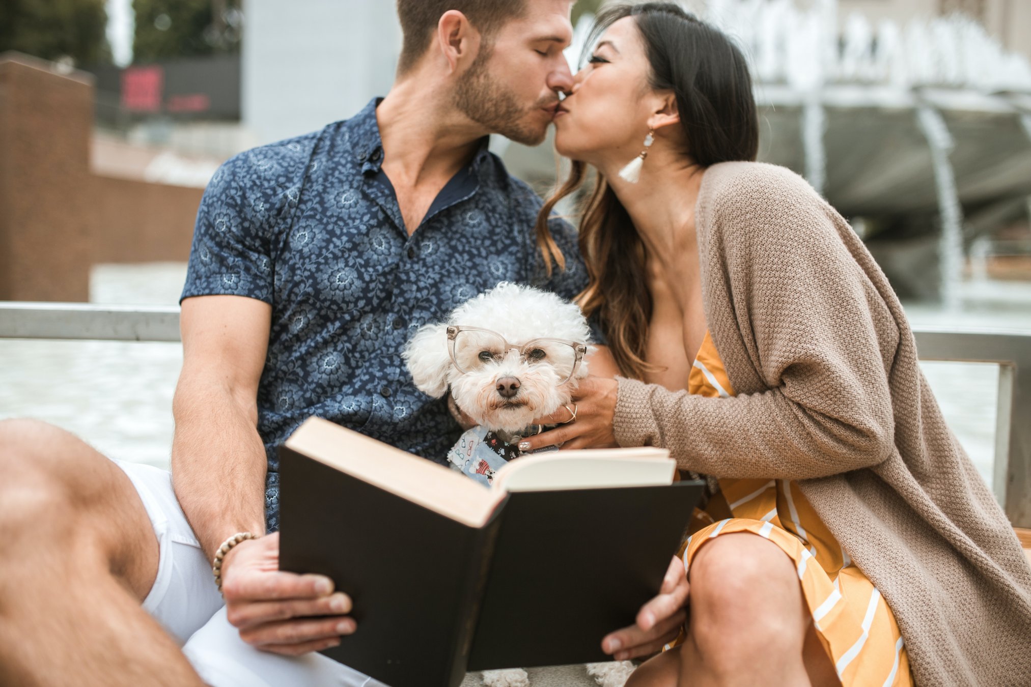 Frases de amor. Pareja con perrito leyendo un libro. 