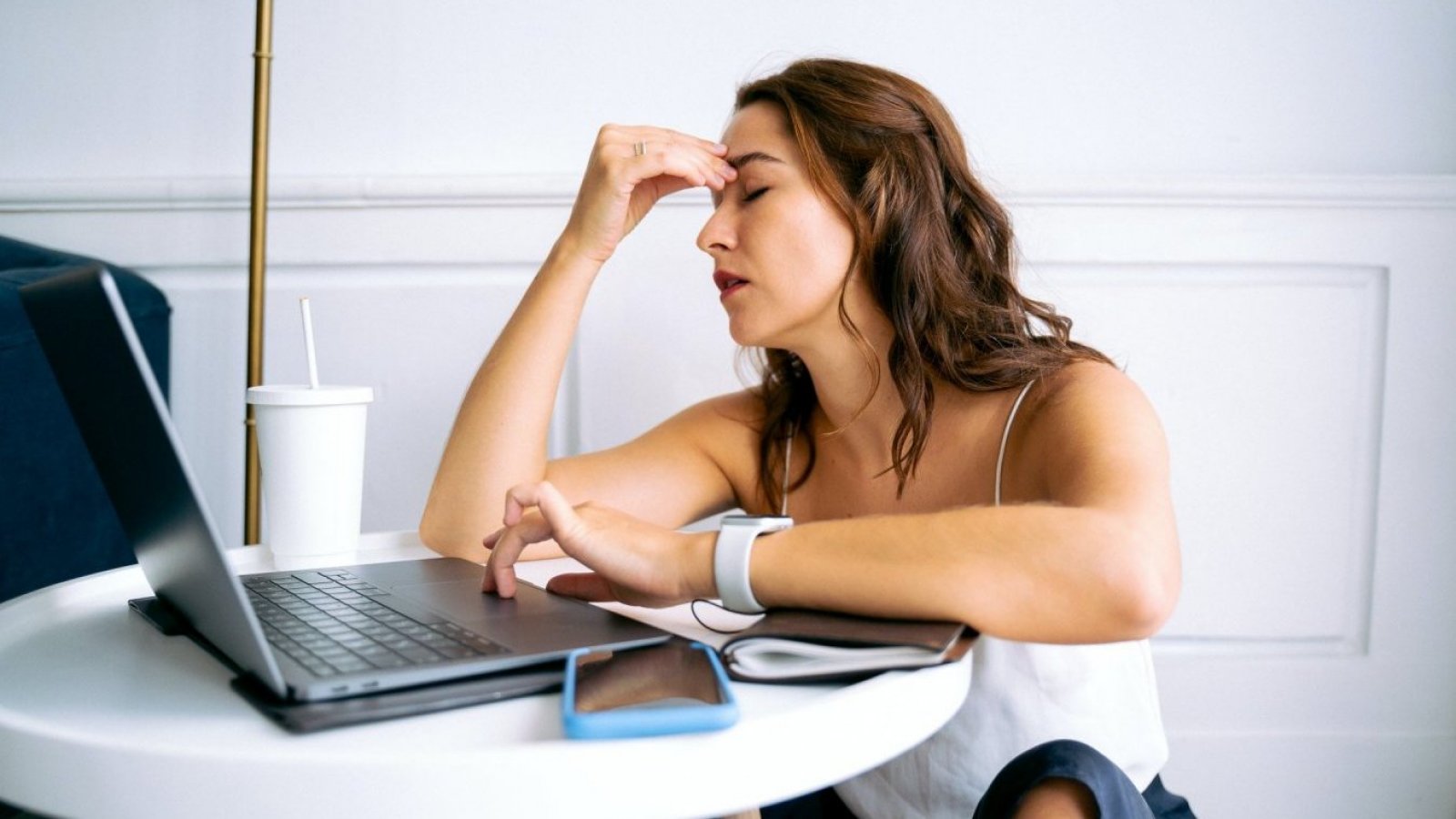 Cambio de hora. Mujer con dolor de cabeza en el trabajo.