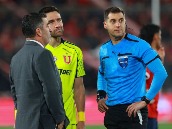 Matías Zaldivia junto al árbitro y personal de la Conmebol en medio de los incidentes ante Independiente