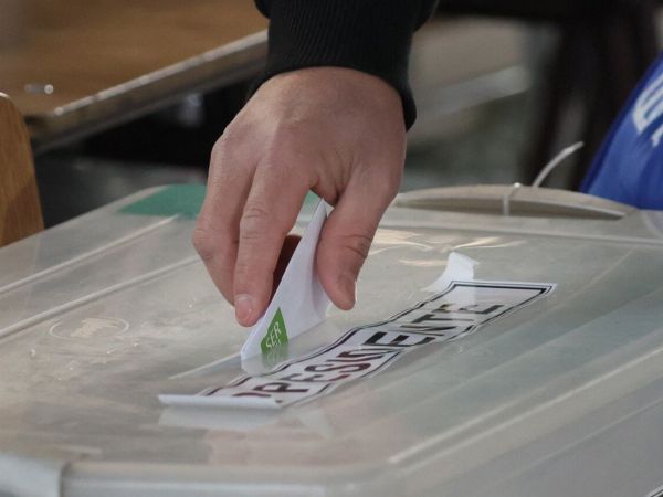 Mano votando en las elecciones 2025